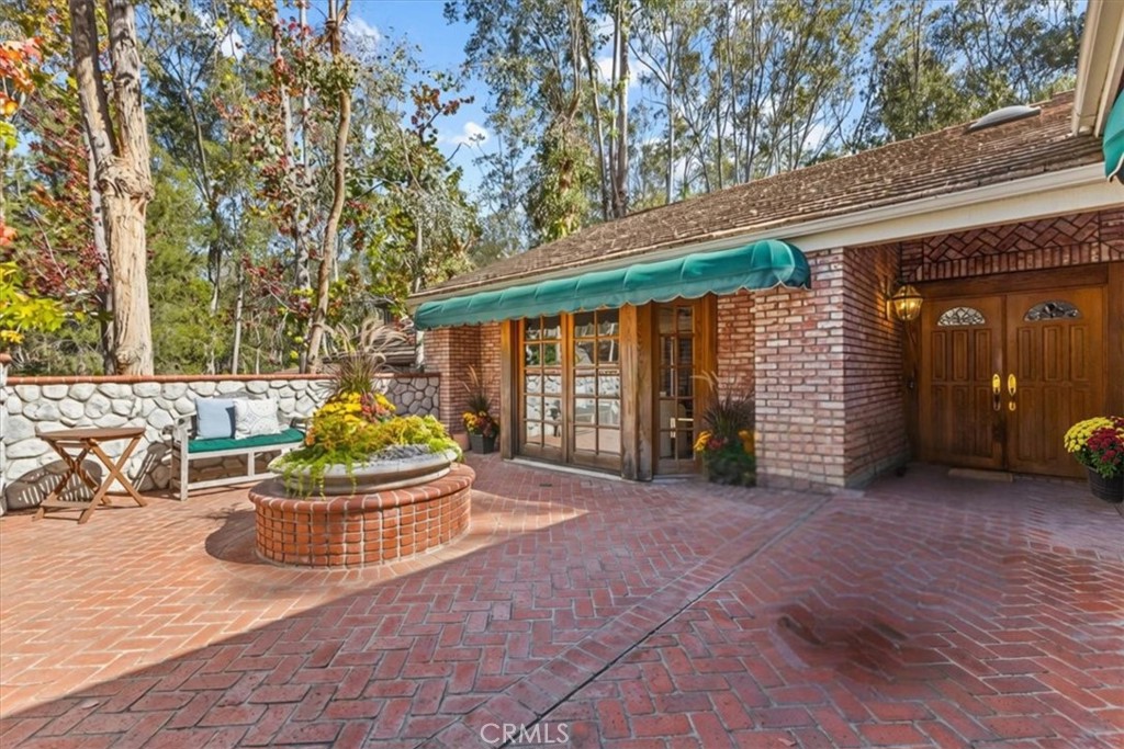 What a great place to enjoy your morning coffee! This spacious brick courtyard features a beautiful planter filled with - 22212 Shady Rim, Lake Forest CA 92630 - photo 2