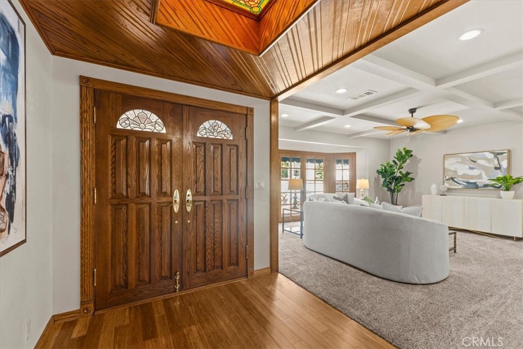 As you enter through the beautiful solid oak double doors, you'll notice the wood-paneled ceiling and stained glass deta - 22212 Shady Rim, Lake Forest CA 92630 - photo 3