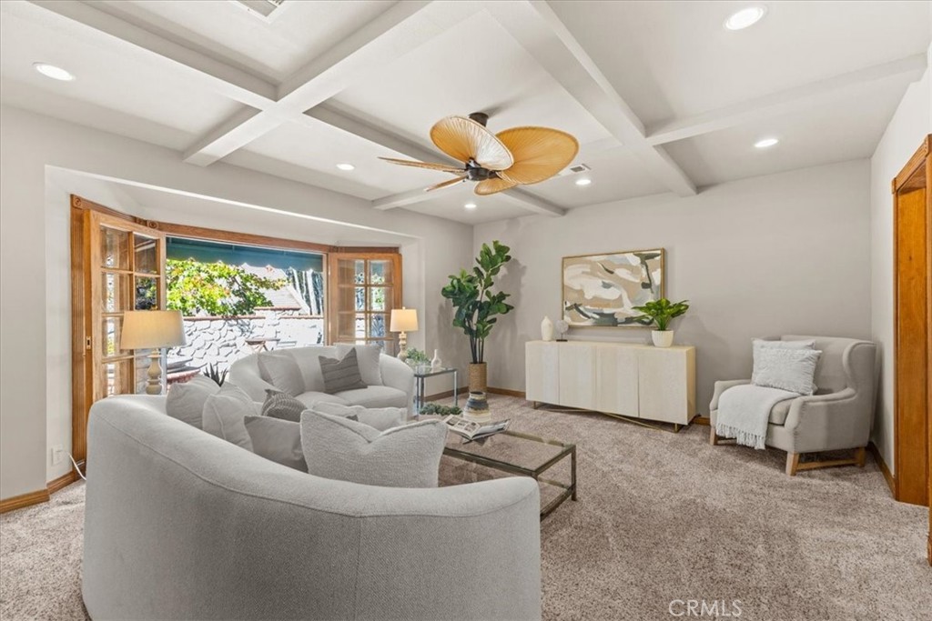 The living room is much larger than most features a beautiful coffered ceiling, recessed lighting, and French doors that - 22212 Shady Rim, Lake Forest CA 92630 - photo 4