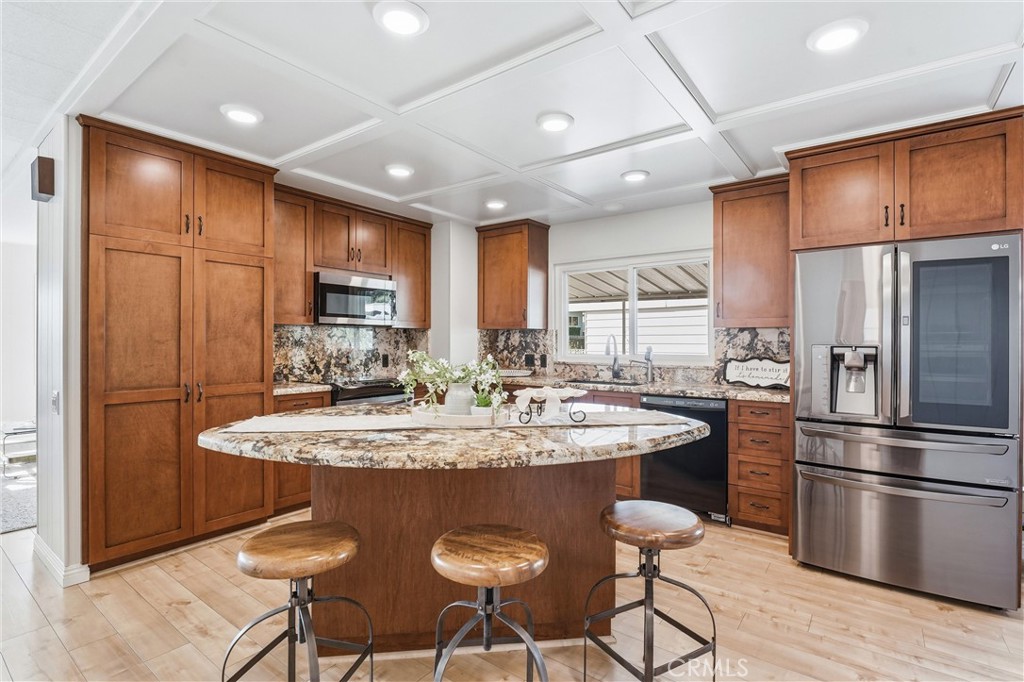 coffered ceilings & stainless appliances - 24001 Muirlands Boulevard 64, Lake Forest CA 92630 - photo 3