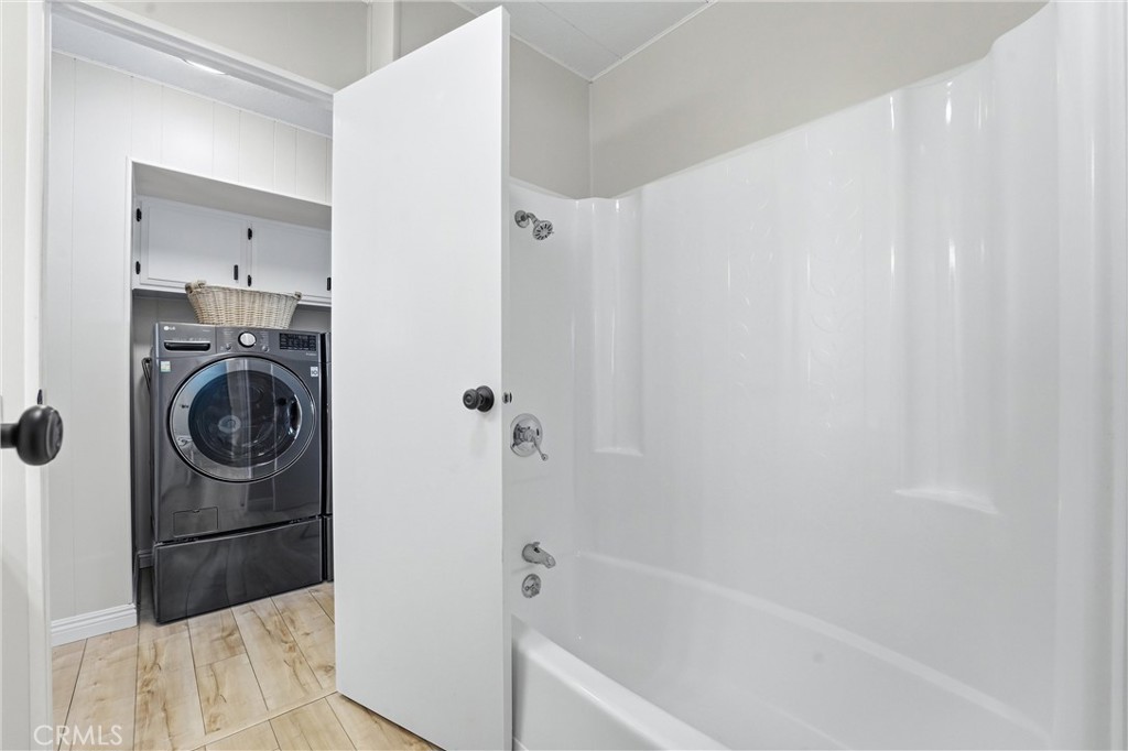 secondary bathroom to laundry room - 24001 Muirlands Boulevard 64, Lake Forest CA 92630 - photo 17
