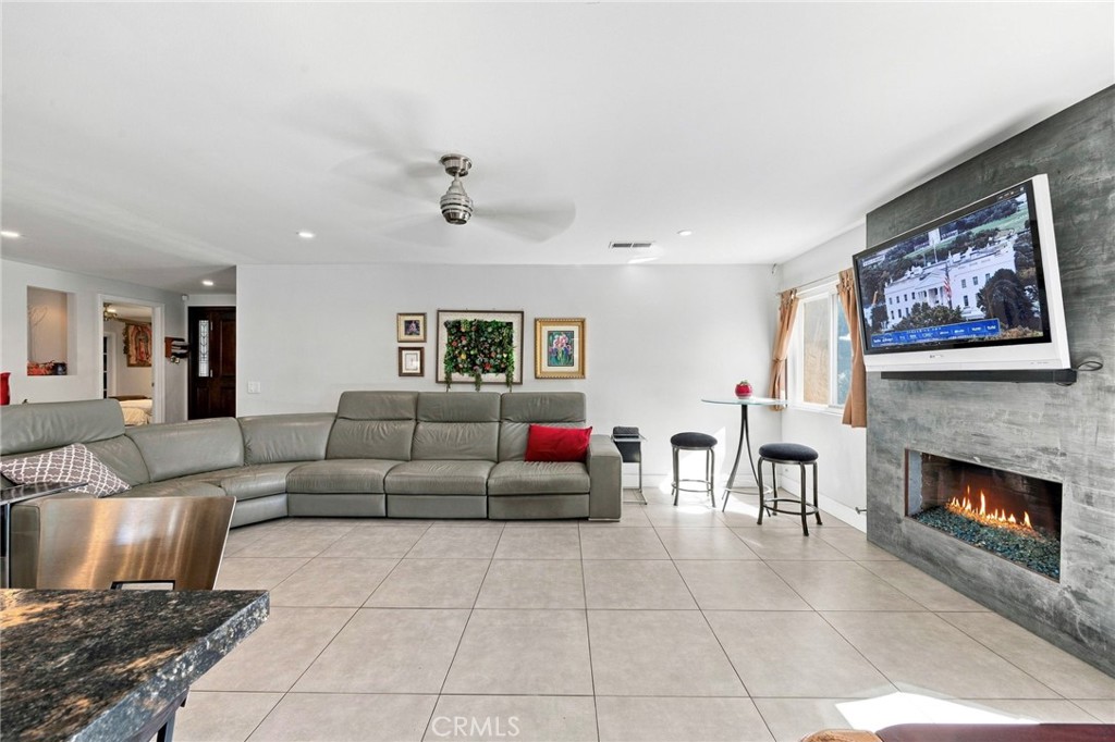 Great room with fireplace, recessed lighting and tile flooring - 24382 Corta Cresta, Lake Forest CA 92630 - photo 8