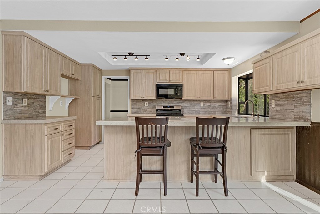 Remodeled kitchen with breakfast counter for your casual meals. - 24712 Via Del Rio, Lake Forest CA 92630 - photo 10