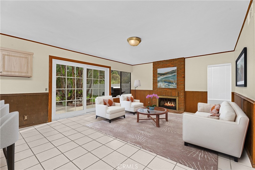 Large family room with cozy fireplace! *Photo is virtually staged. - 24712 Via Del Rio, Lake Forest CA 92630 - photo 11