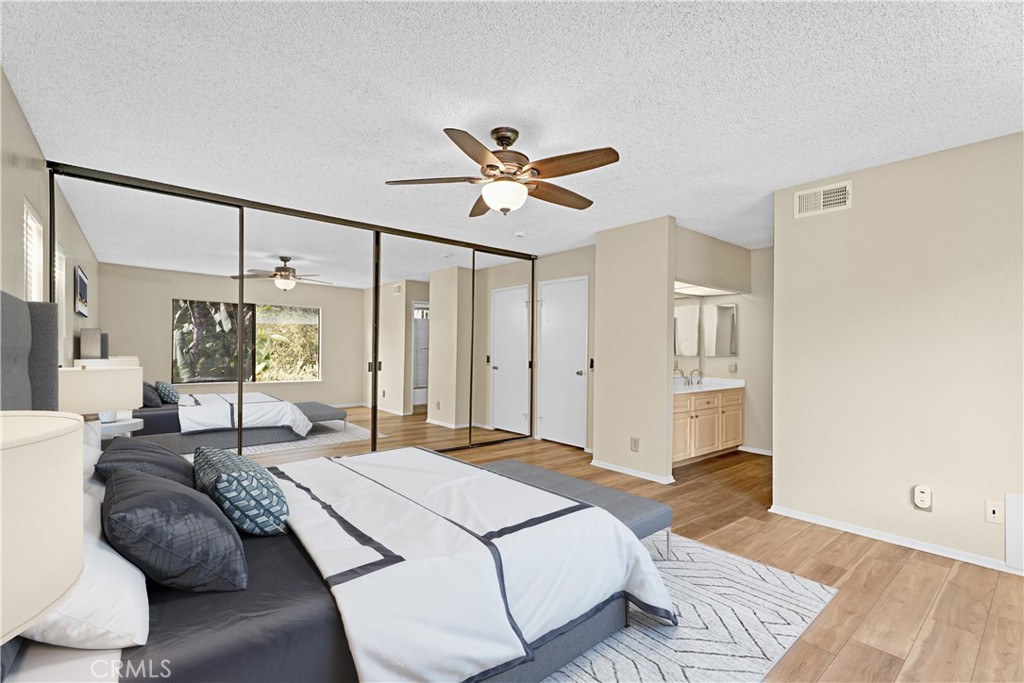 Large primary bedroom with private bathroom. Enjoy the wall to wall closet space. *Photo is virtually staged. - 24712 Via Del Rio, Lake Forest CA 92630 - photo 13