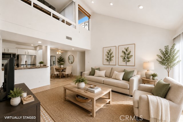 Spacious living room with vaulted ceilings and an abundance of natural light. (virtually staged) - 25761 Le Parc 82, Lake Forest CA 92630 - photo 1