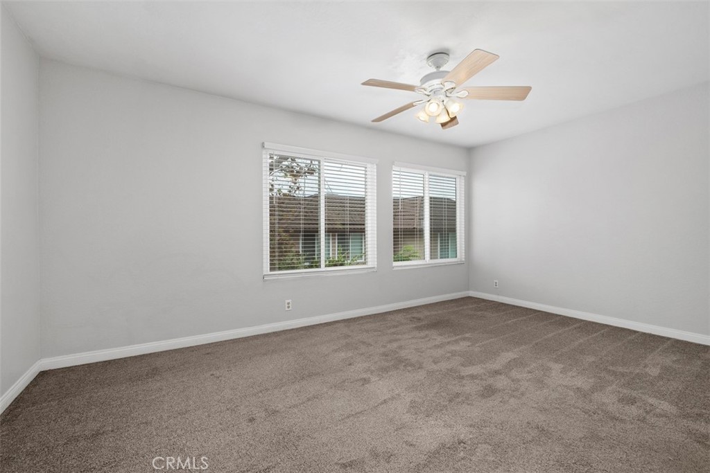 This is the other secondary bedroom complete with ceiling fan and walk-in closet - 25885 Trabuco 16, Lake Forest CA 92630 - photo 6