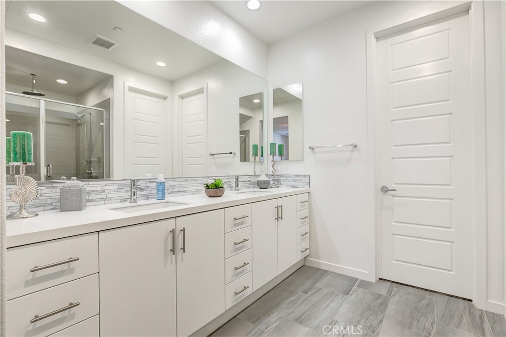 Primary bathroom with upgraded counters, shower & large closet - 47 Prominence, Lake Forest CA 92630 - photo 15