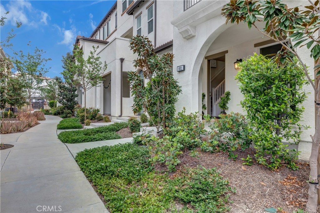 Lush green walkway leading to your next home - 601 Shadowbrook, Lake Forest CA 92610 - photo 1