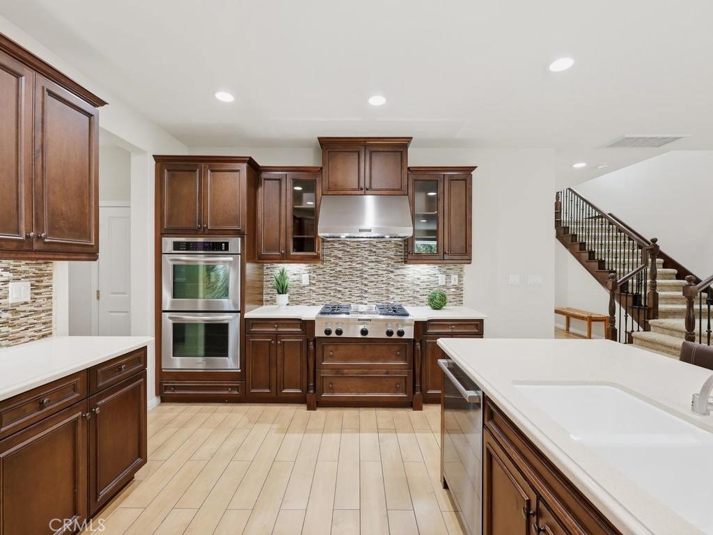 Double oven, gas stove top with grill and hood - 8 Willow Way, Lake Forest CA 92630 - photo 1