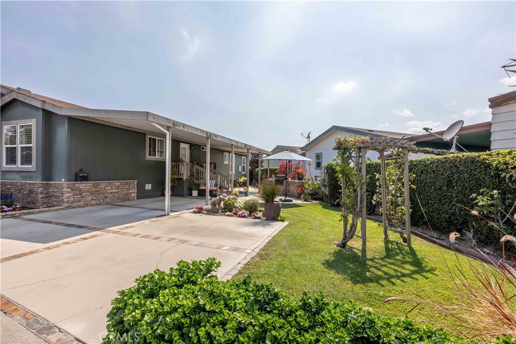 built in bbq area with grass and table/umbrella - 10681 Oak Street 106, Los Alamitos CA 90720 - photo 7