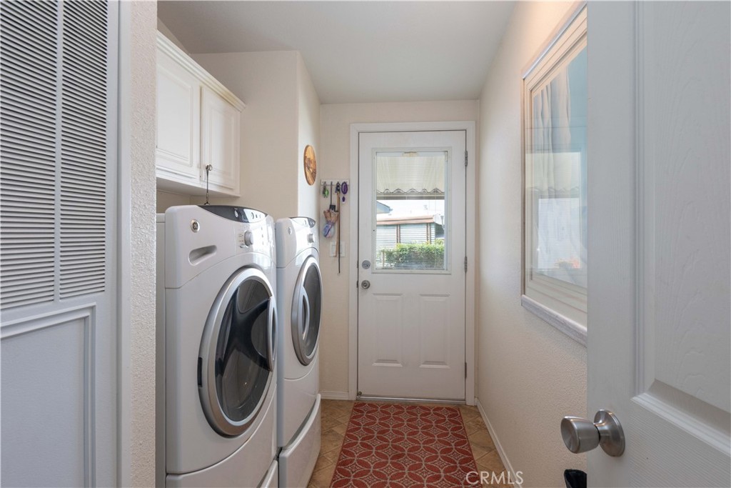 Laundry room with side access door - 10681 Oak Street 106, Los Alamitos CA 90720 - photo 21