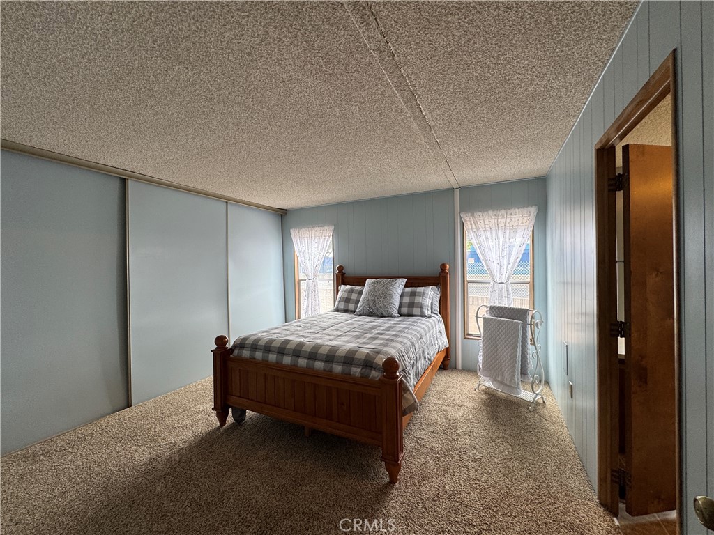 Master Bedroom with Full Wall Triple Door Closet - 10681 Oak Street 58, Los Alamitos CA 90720 - photo 14