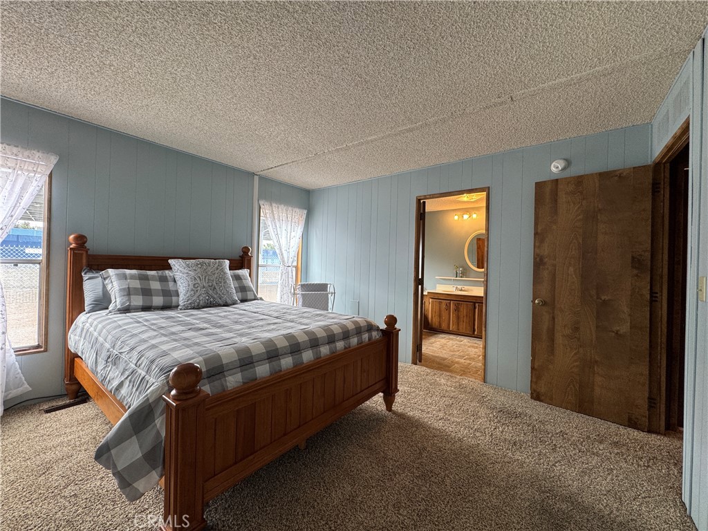 Master Bedroom with adjacent Bathroom - 10681 Oak Street 58, Los Alamitos CA 90720 - photo 15