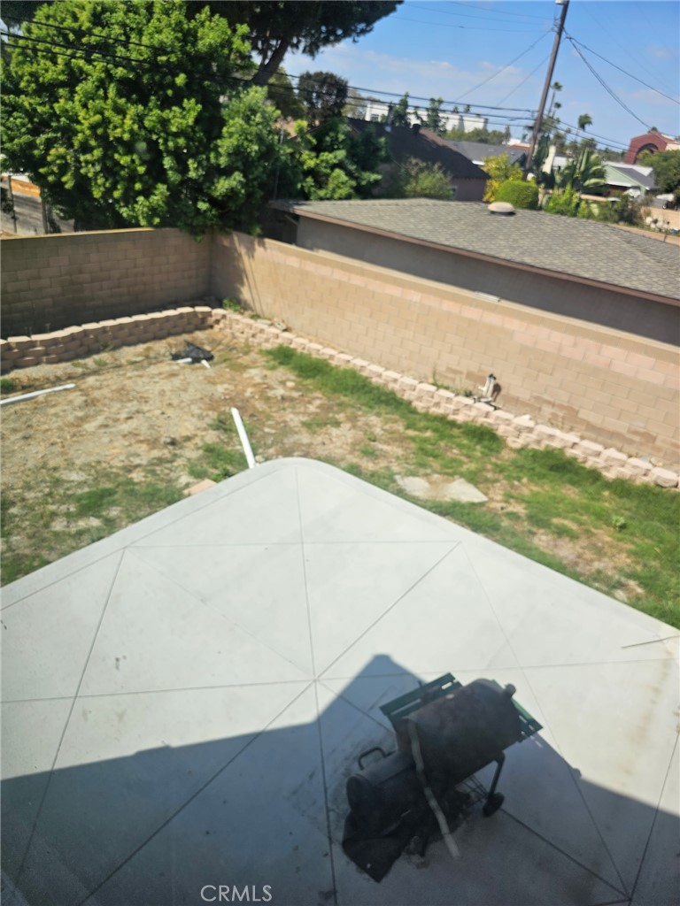 View of backyard and cement patio area - 11101 Essex Drive, Los Alamitos CA 90720 - photo 18