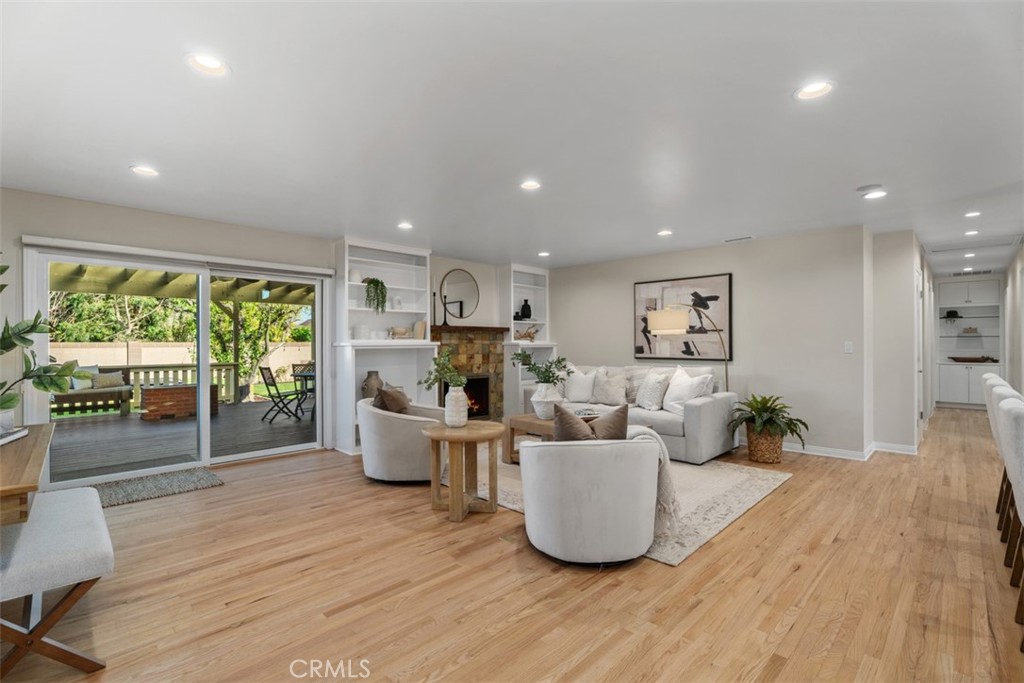 Open concept Living Area. Recently refinished red oak floors, LED recessed lighting, wired for sound, access to backyard - 11772 Paseo Bonita, Los Alamitos CA 90720 - photo 12