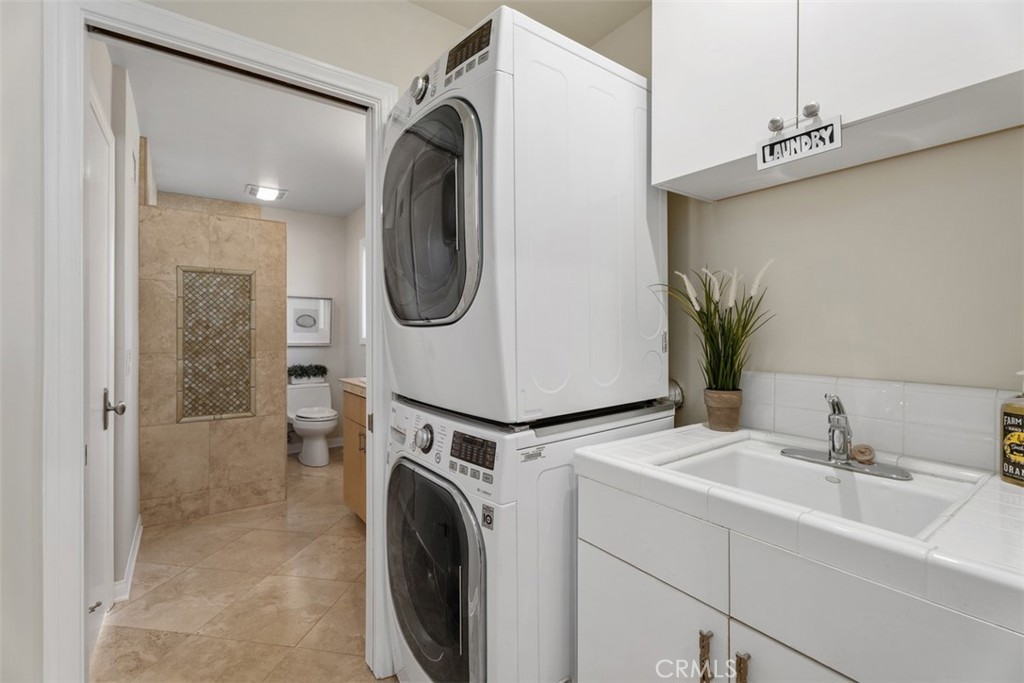Separate indoor laundry room with sink & storage. - 11772 Paseo Bonita, Los Alamitos CA 90720 - photo 16