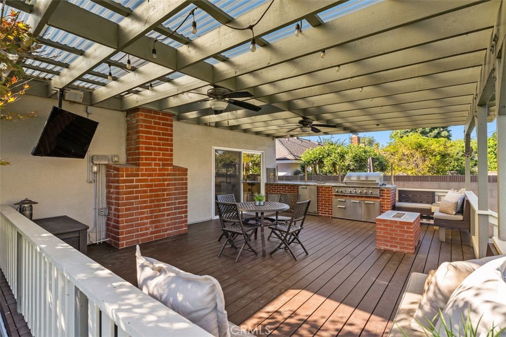 Built-in bench seating, ceiling fans, flat screen TV & decorative lights make this outdoor space an extension of the alr - 11772 Paseo Bonita, Los Alamitos CA 90720 - photo 27