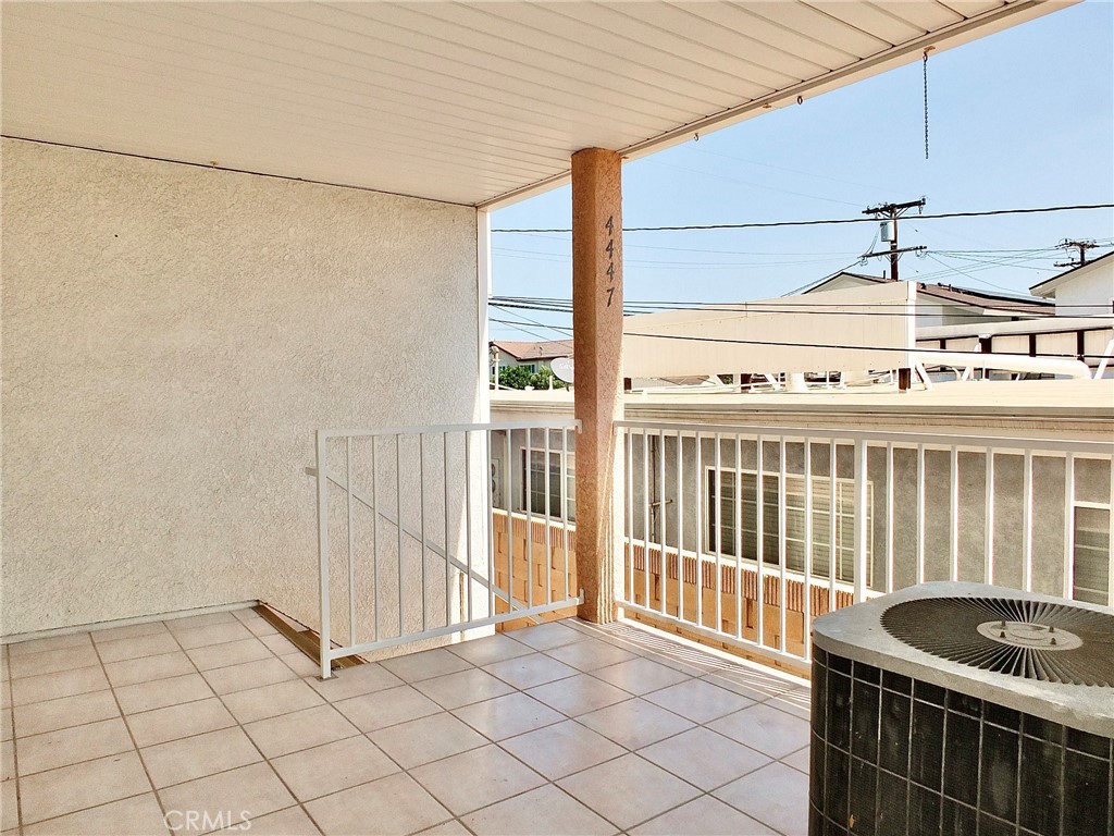 Spacious front porch where A/C unit is located. - 4441 Farquhar, Los Alamitos CA 90720 - photo 4