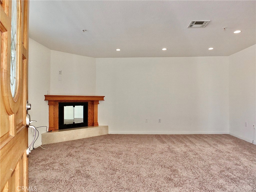 Spacious living room with gas fireplace, new carpeting and recessed lighting. - 4441 Farquhar, Los Alamitos CA 90720 - photo 5