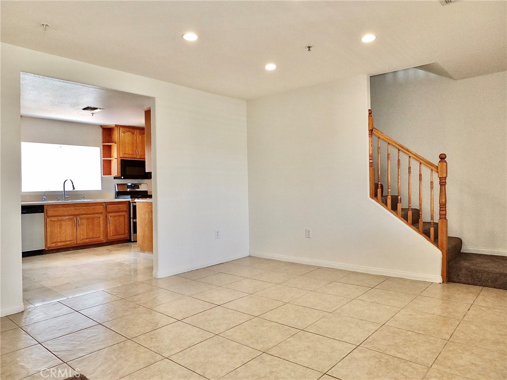 View from dining room looking into the kitchen and stairway leading to the bedrooms - 4441 Farquhar, Los Alamitos CA 90720 - photo 10