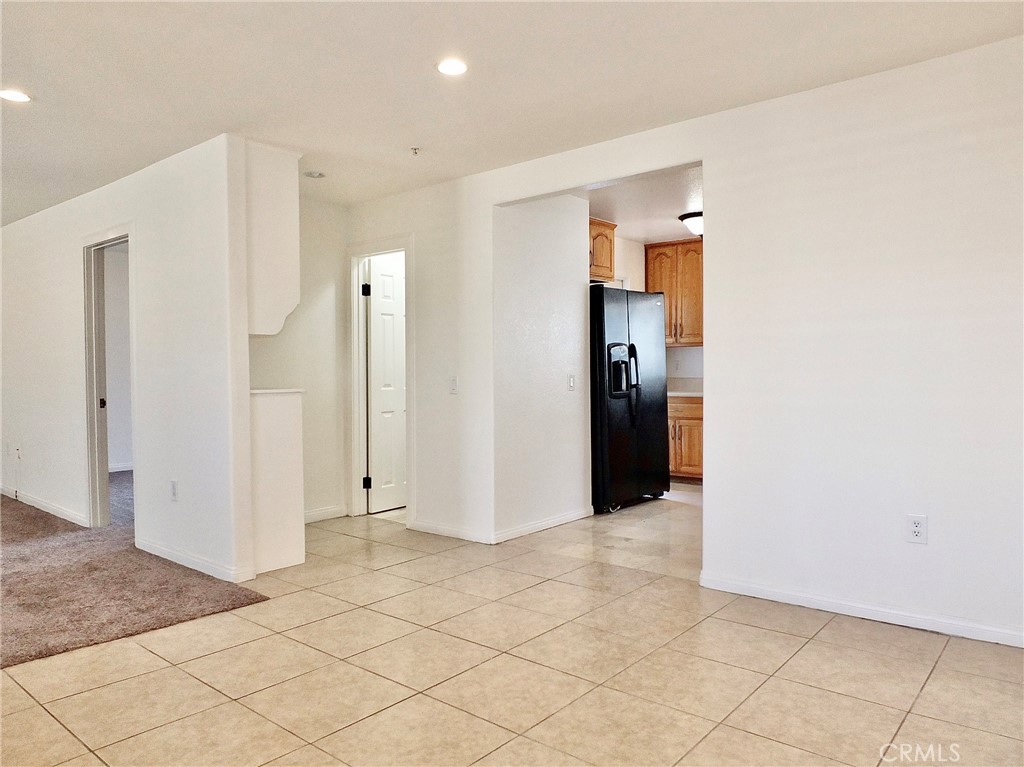 iew from the dining room toward the kitchen and downstairs bathroom, which offers storage cabinets. The room off the liv - 4441 Farquhar, Los Alamitos CA 90720 - photo 12