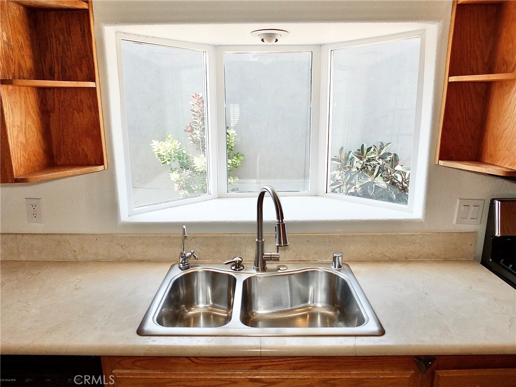 The garden kitchen window fills the space with sunshine and offers display shelves for your favorite vases or plants. - 4441 Farquhar, Los Alamitos CA 90720 - photo 15