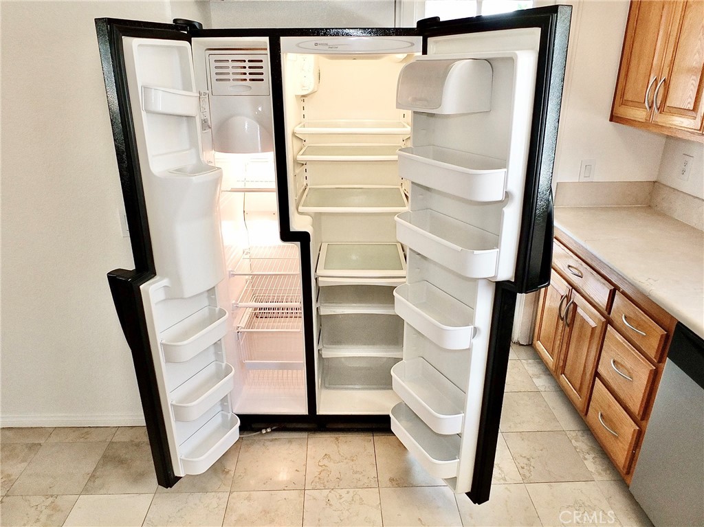 View of side by side refrigerator/freezer included in the sale. - 4441 Farquhar, Los Alamitos CA 90720 - photo 19