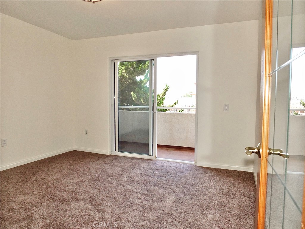 The room off the living room offers flexible space for a home office or children’s playroom. Sliding glass doors open to - 4441 Farquhar, Los Alamitos CA 90720 - photo 20