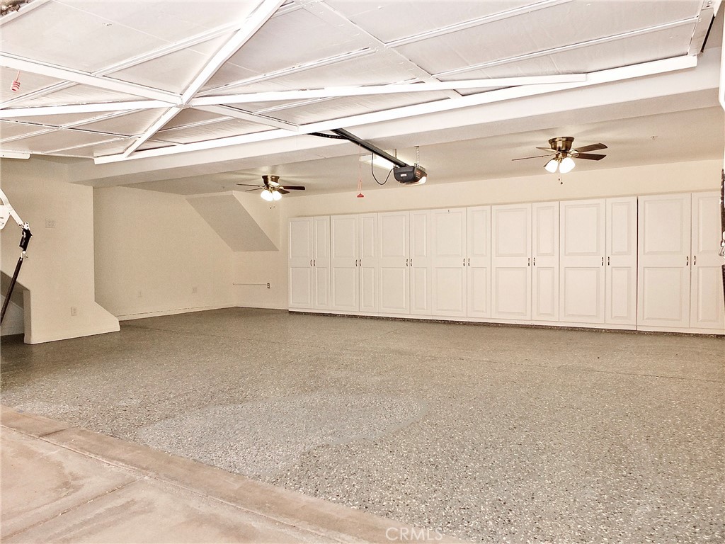 Spacious garage with an entire wall of storage cabinets. - 4441 Farquhar, Los Alamitos CA 90720 - photo 24