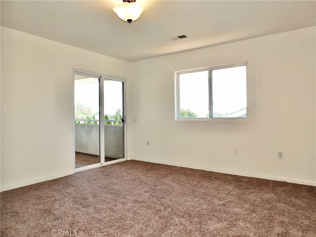 Another view of the primary bedroom, with access to a balcony where you can relax and enjoy the outdoors. - 4441 Farquhar, Los Alamitos CA 90720 - photo 28