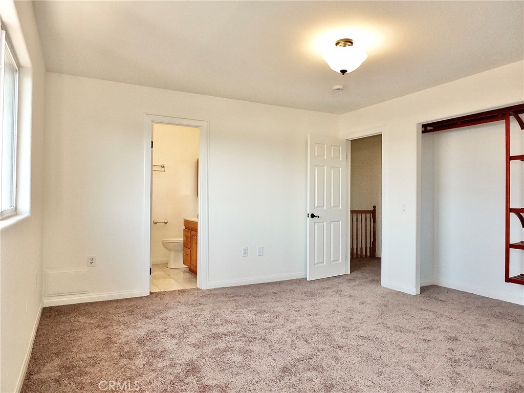 Primary bedroom looking out to hallway, primary bathroom and closet - 4441 Farquhar, Los Alamitos CA 90720 - photo 31