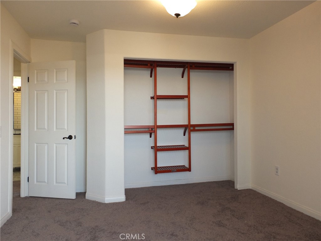 Bedroom next to primary bedroom with view of the closet. - 4441 Farquhar, Los Alamitos CA 90720 - photo 37
