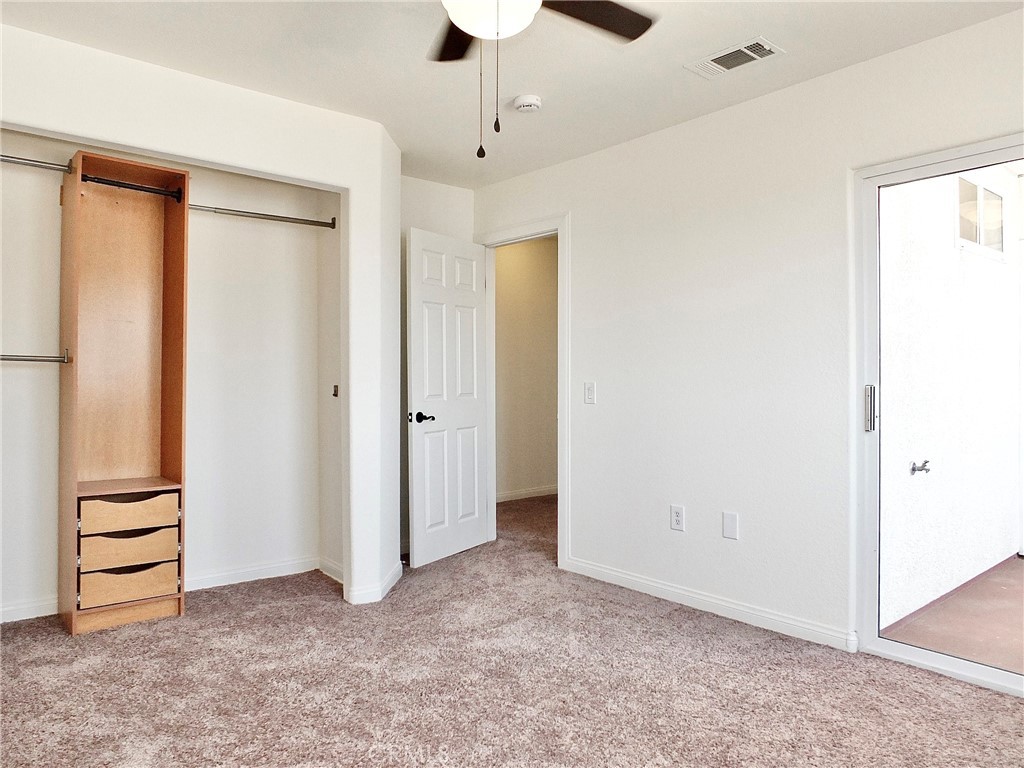 Another view of back bedroom closet with organizer shelves looking into hallway. - 4441 Farquhar, Los Alamitos CA 90720 - photo 43