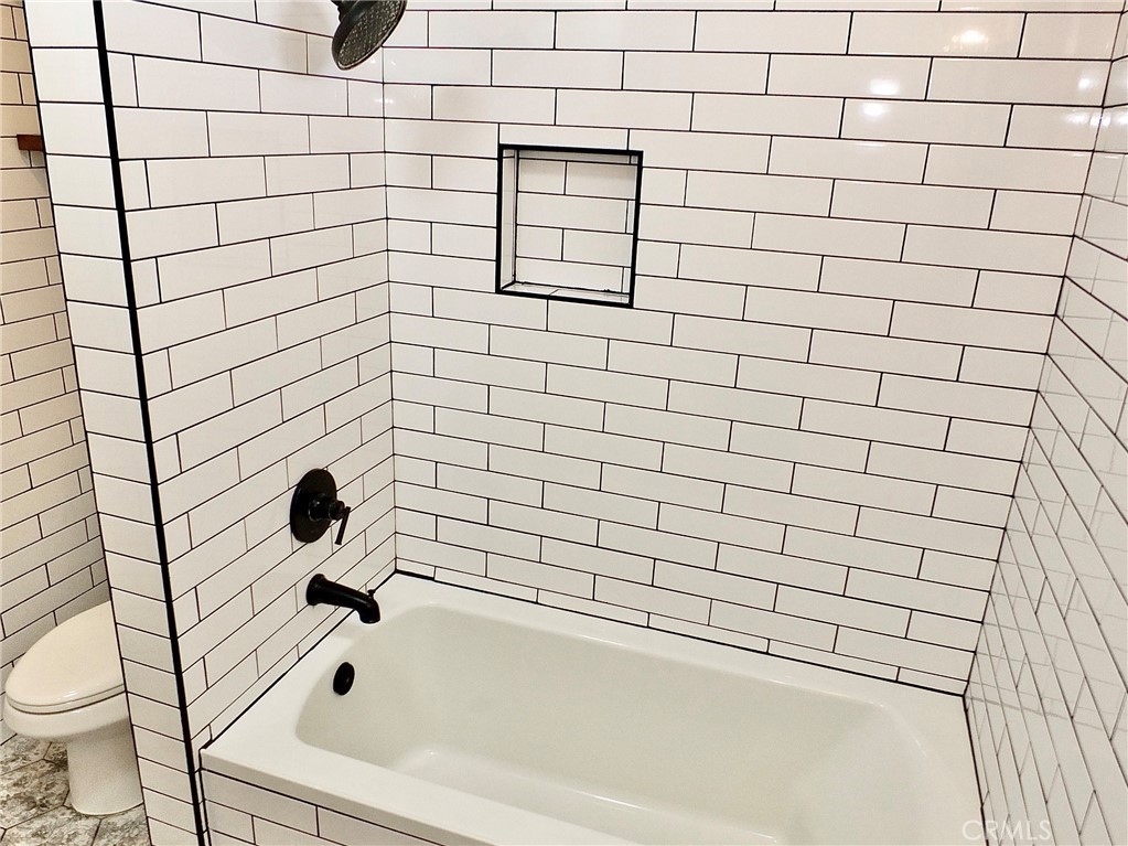View of toilet and tub/shower combo - 4441 Farquhar, Los Alamitos CA 90720 - photo 45