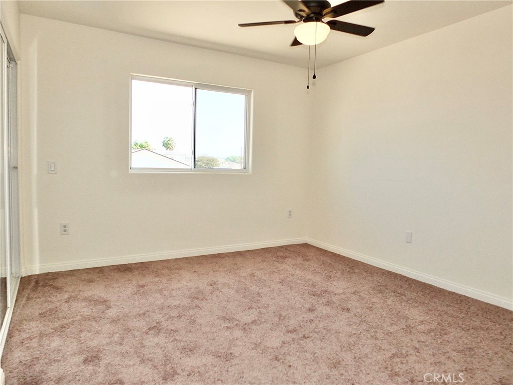 4th bedroom across the primary bedrooms with ceiling light and fan and new carpeting - 4441 Farquhar, Los Alamitos CA 90720 - photo 46
