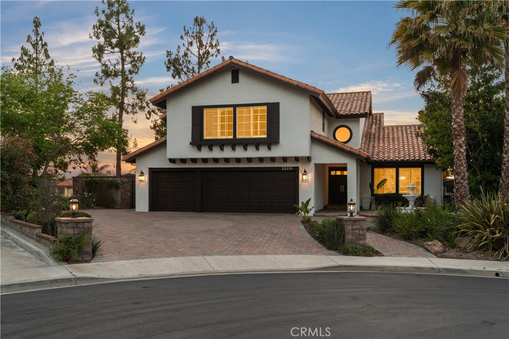 Set on a quiet cul-de-sac, featuring elegant curb appeal, a spacious paver driveway, and a welcoming entry. - 22231 Stillwater, Mission Viejo CA 92692 - photo 1