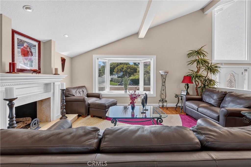 Large Living Room with gas burning romantic fireplace and custom mantle surround. - 22852 Buendia, Mission Viejo CA 92691 - photo 5