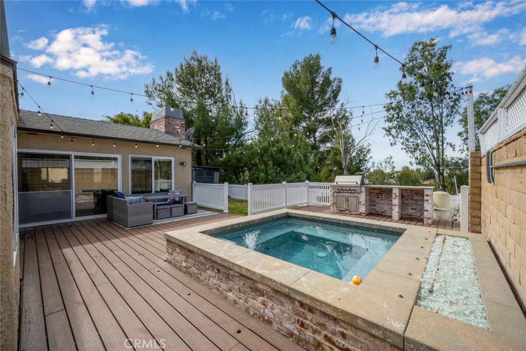 Elevated spa with fire feature, built-in BBQ island, and café lighting creating a true resort-style outdoor retreat.All - 22995 Via San Juan, Mission Viejo CA 92691 - photo 1