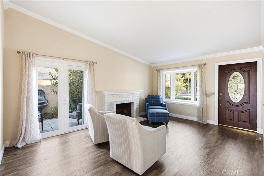 Spacious front living room with custom french doors, bay window, and fireplace. - 23001 Via Santa Maria, Mission Viejo CA 92691 - photo 2