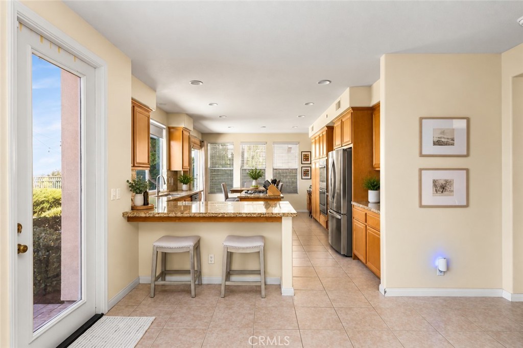 Large family kitchen with breakfast bar seating. - 23041 Poplar, Mission Viejo CA 92692 - photo 12