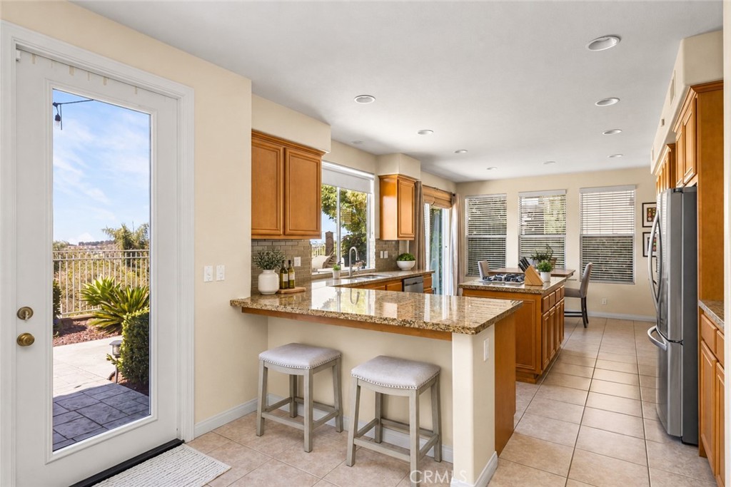 Patio access door leads you to the backyard with city and mountain views. - 23041 Poplar, Mission Viejo CA 92692 - photo 13