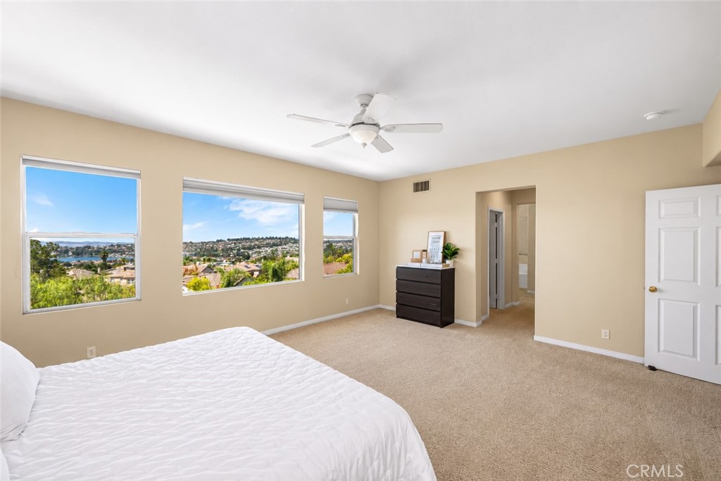 Primary suite with ceiling fan and views of lake Mission Viejo and city. - 23041 Poplar, Mission Viejo CA 92692 - photo 21