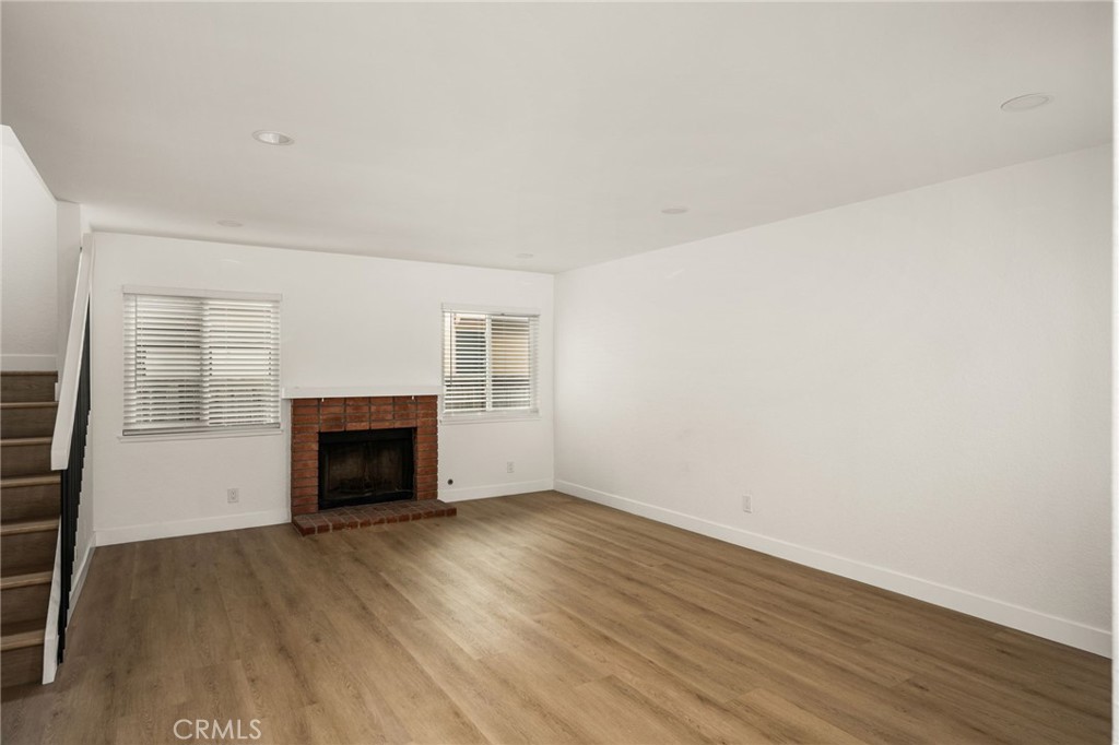 Large living room with new flooring and cozy fireplace - 24112 Zancon, Mission Viejo CA 92692 - photo 2