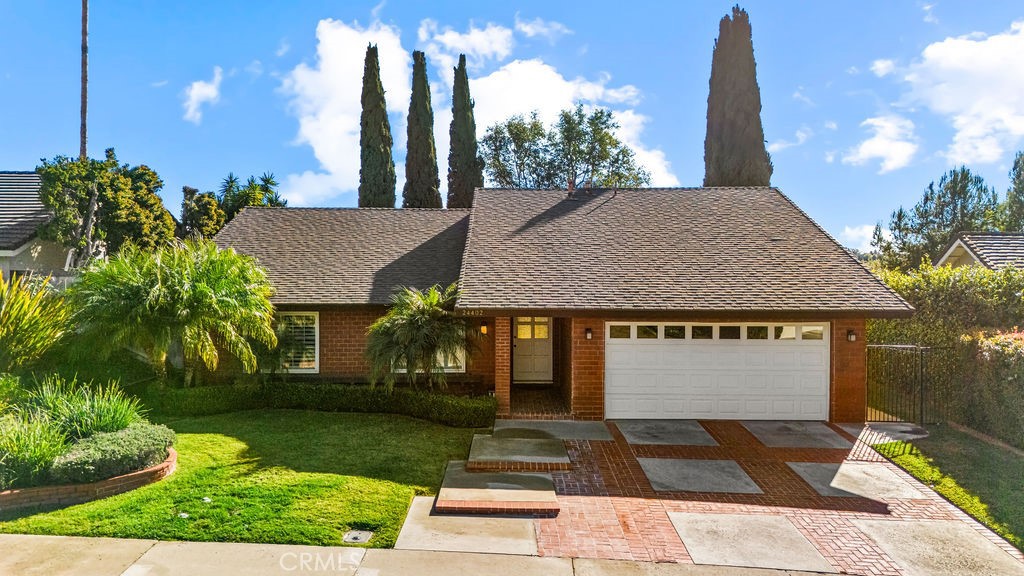 Welcoming front elevation showcasing classic single-story design, mature landscaping, and excellent curb appeal. - 24402 Chrisanta Drive, Mission Viejo CA 92691 - photo 1