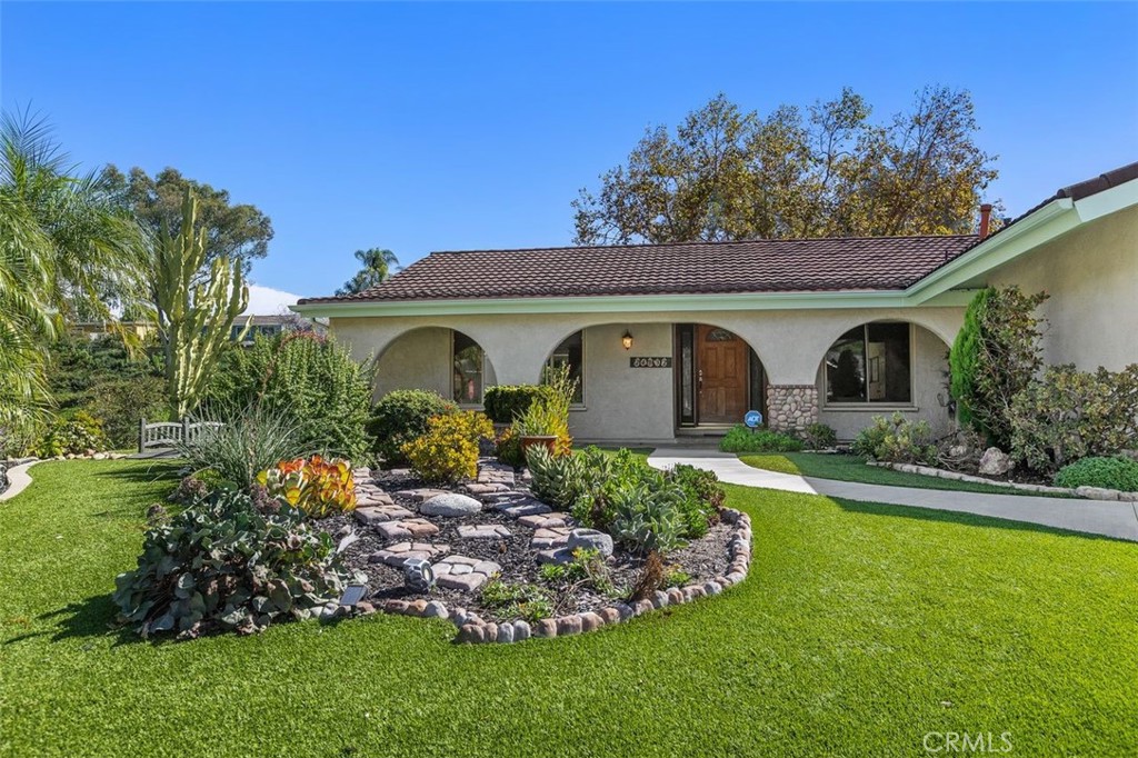 Charming landscaping and artificial grass keep it looking green all year long! - 24832 El Cortijo, Mission Viejo CA 92691 - photo 2