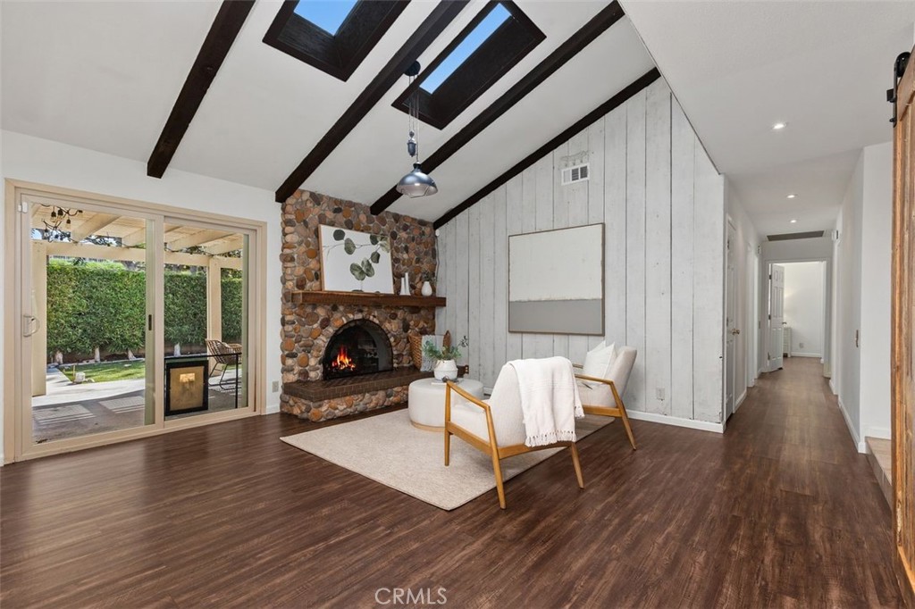 Living room featuring the stone fireplace. - 24832 El Cortijo, Mission Viejo CA 92691 - photo 4