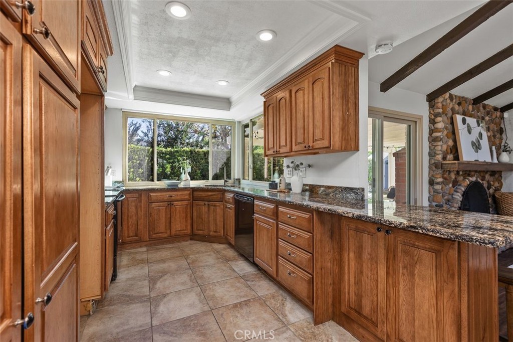 Recessed lighting and natural wood cabinetry lend itself to a charming area to create gourmet meals. - 24832 El Cortijo, Mission Viejo CA 92691 - photo 9