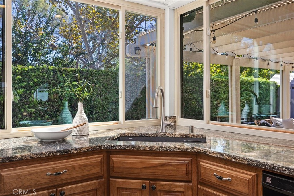 Newer windows frame the kitchen area looking outside. - 24832 El Cortijo, Mission Viejo CA 92691 - photo 11