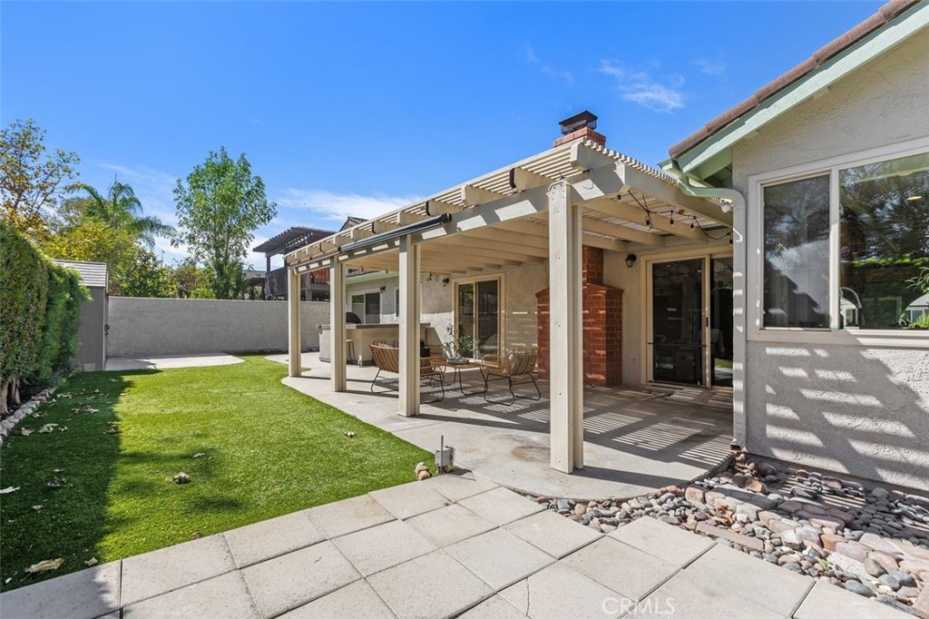Enjoy the low maintenance backyard artificial lawn and concrete pavers. Who doesn't love a covered patio too? - 24832 El Cortijo, Mission Viejo CA 92691 - photo 21